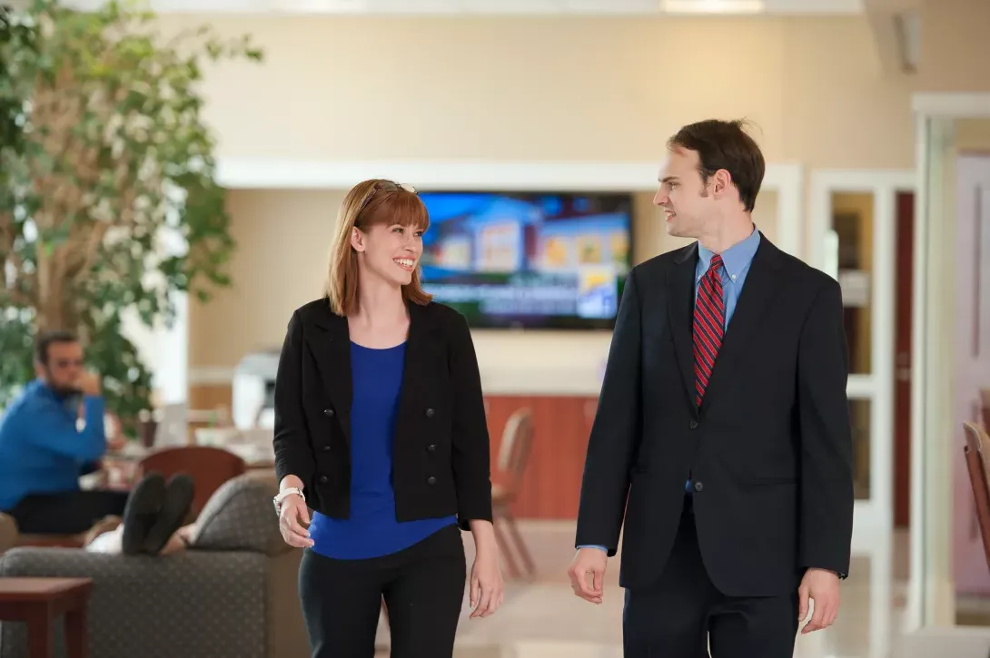 Nursing students in formal clothes in the walking in the lobby of the Dwight Schar College of Nursing and Health Sciences